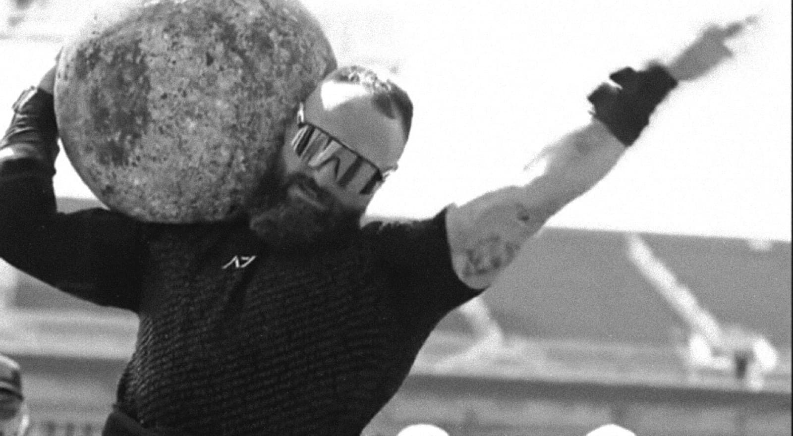 Sean Riley shouldering an atlas stone at a competition.