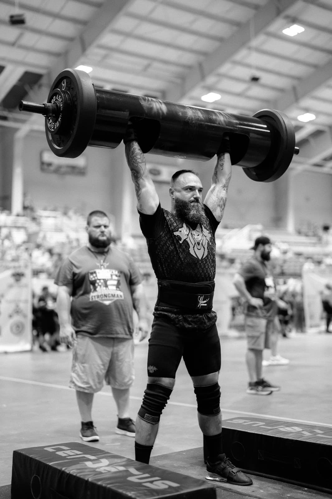 Sean Riley pressing a competition log overhead to lockout.