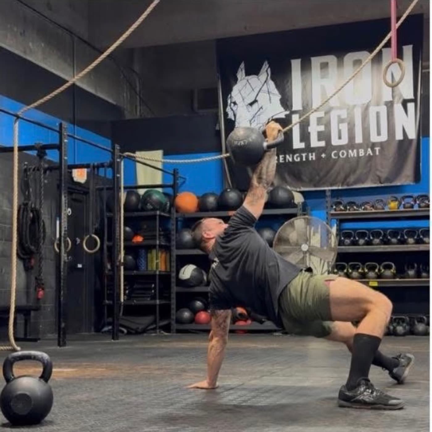 Kettlebell work on the training floor at Iron Legion Strength Club.